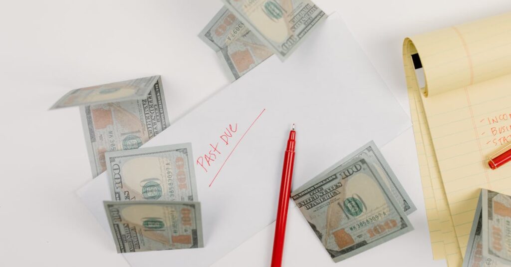 A top-down view of scattered US dollar bills with a 'past due' envelope, red pen, and notepad.